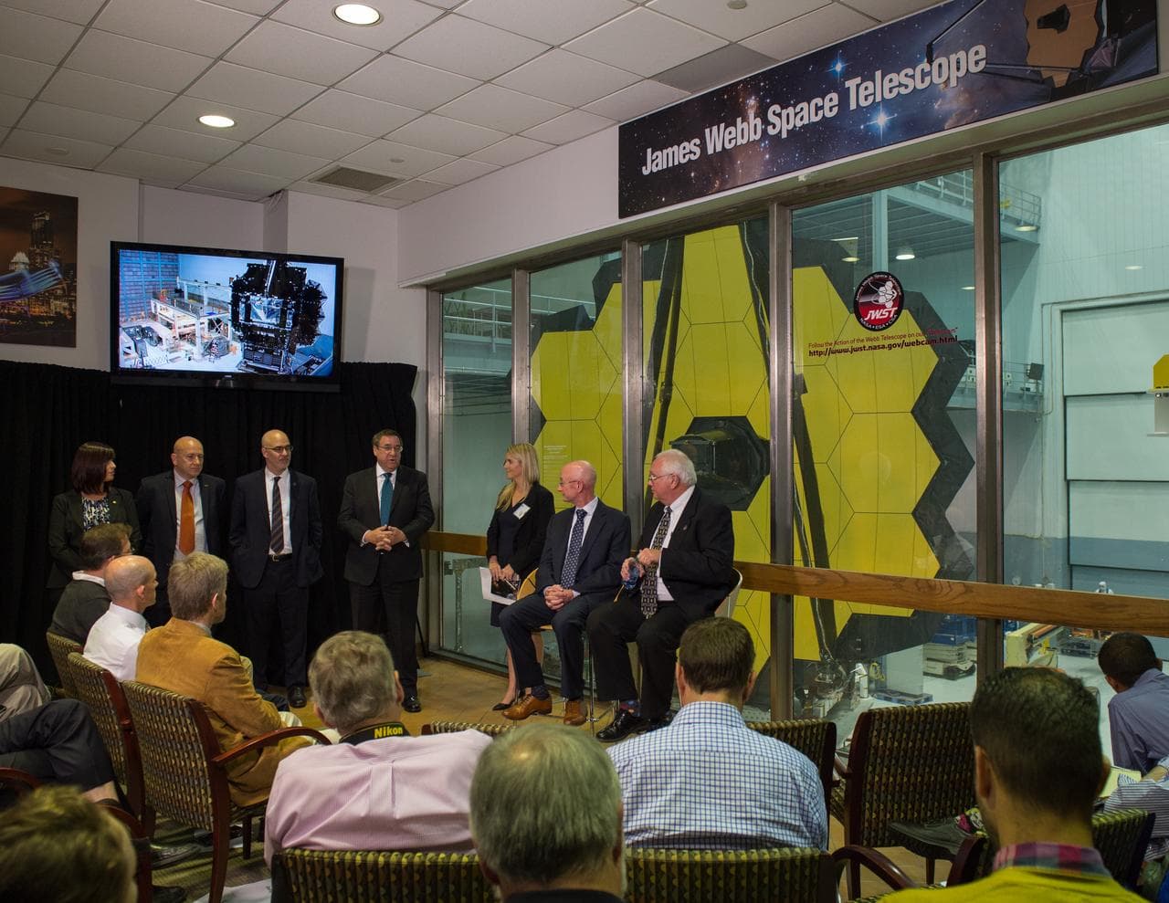 Technicians beside the Webb telescope mirror
